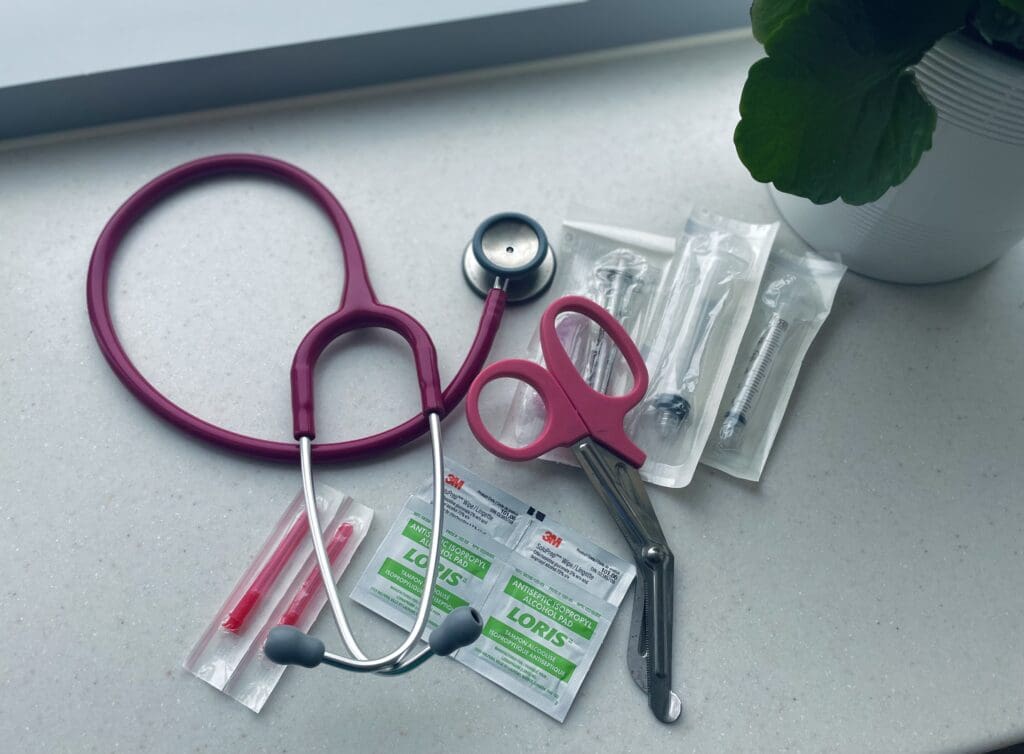 Overlay of items in nursing day-to-day: stethoscope, syringes, blunt needles, and alcohol swabs.