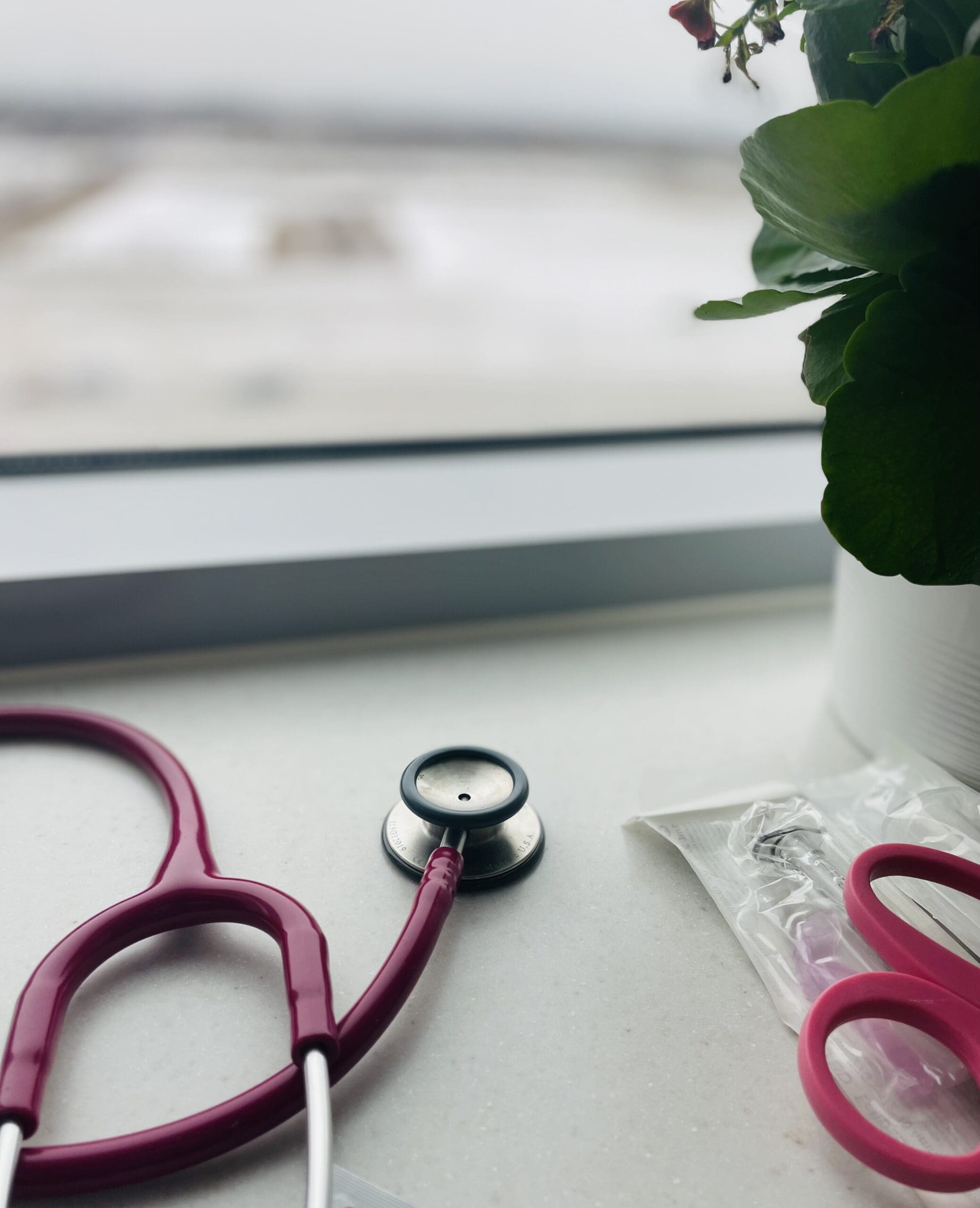 Overlay of items nurses use on a given shift--stethoscope, scissors, and syringes.